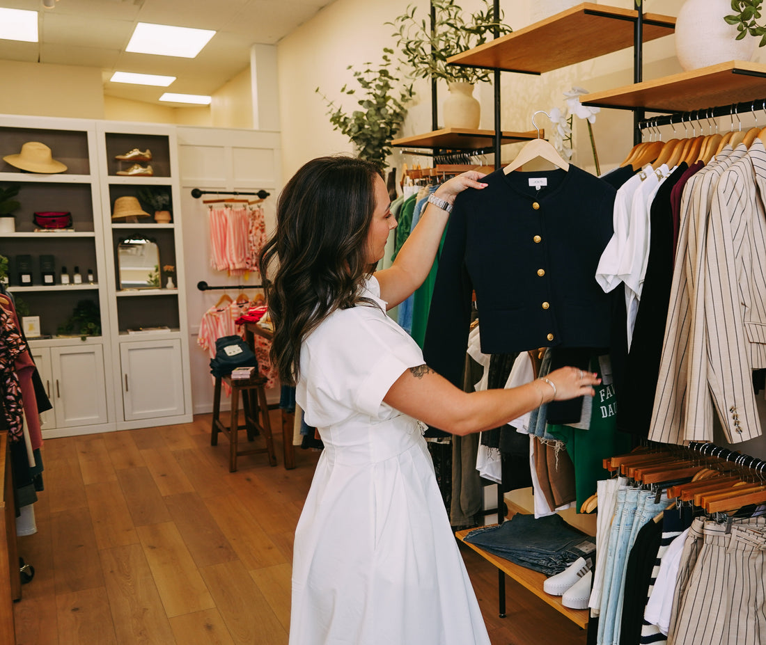 Jenna pulling pieces from the racks at Style Curated in Old Town Fort Collins