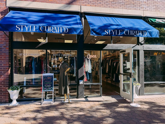 The Style Curated storefront with navy awnings in Old Town Square, Fort Collins